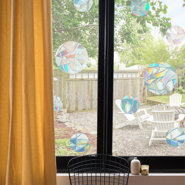 Close-up of a static cling rainbow prism window decal, showcasing its light-refracting properties & vibrant colors.