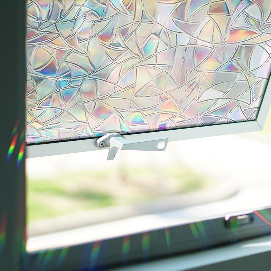 Geometric sun catcher window decals, casting multiple rainbows, enhancing home decor while preventing bird strikes.