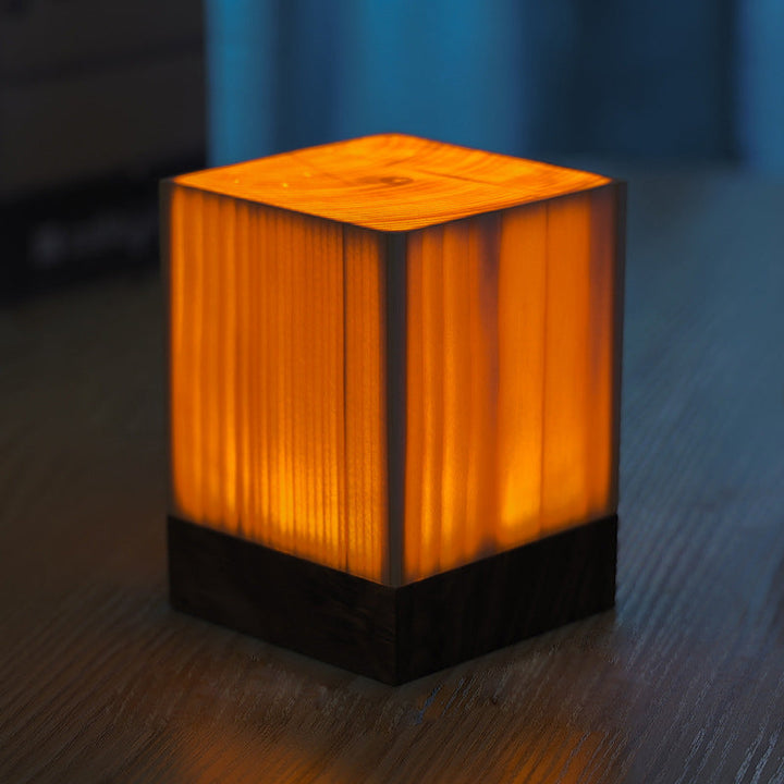 Dimmable LED table lamp with warm wood grain texture, ideal for cozy ambient light.