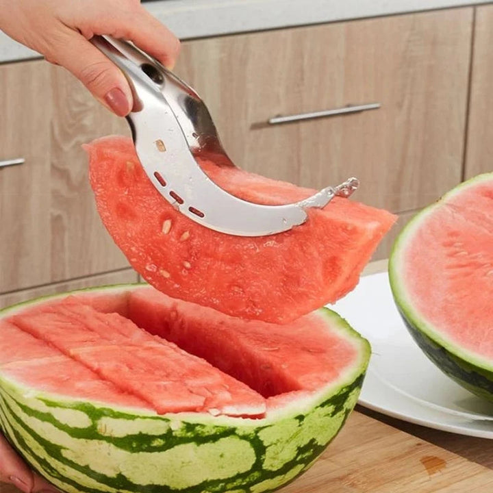 Silver stainless steel fruit slicer for quick kitchen prep. Efficient gadget for healthy fruit snacks.