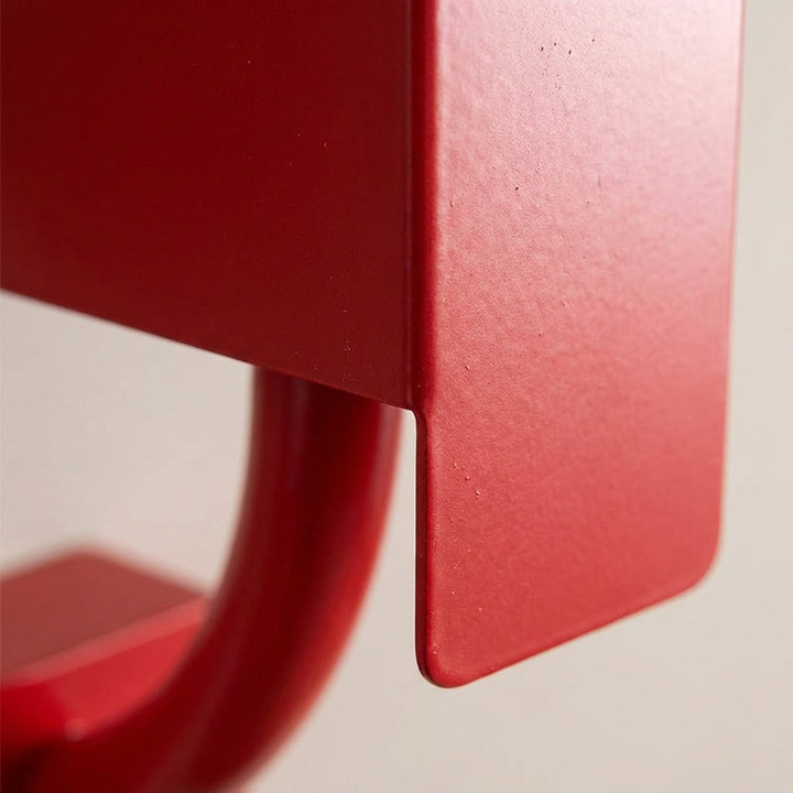 CubiLuxe red geometric triple-bulb wall sconce, a decorative fixture providing ambient lighting in a living room