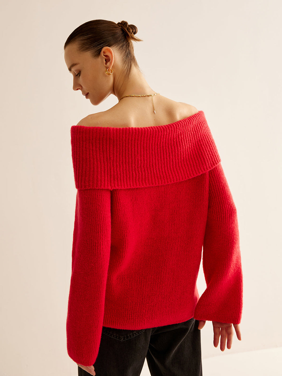 Trendy women's red off-shoulder knit sweater. Soft long-sleeve knitwear, a stylish choice for fall & winter fashion.