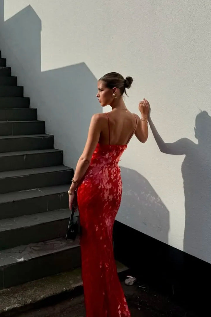 Stunning red sequin prom dress with a daring backless design. Elegant mermaid silhouette, perfect for special occasions.
