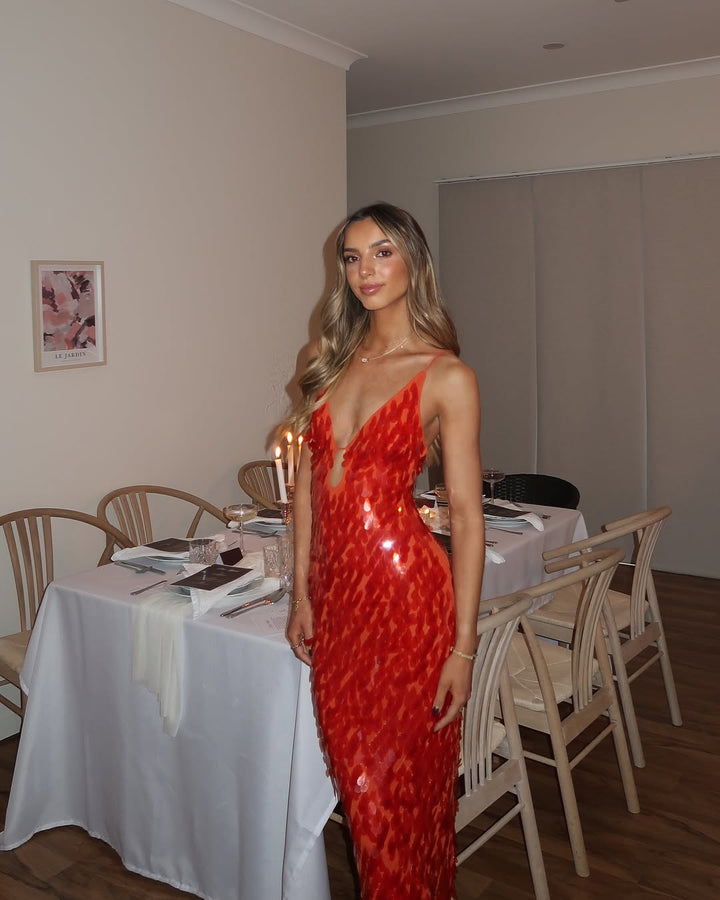 Shimmering red sequin homecoming dress. Elegant backless mermaid style perfect for prom & formal events.