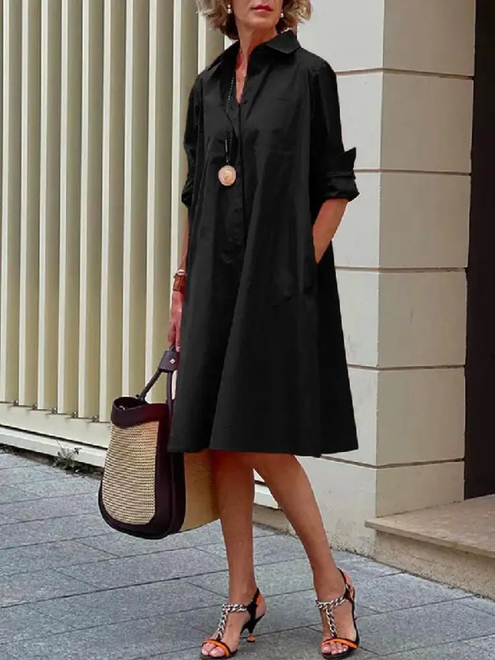 Relaxed A-line button-front midi shirt dress for women. Versatile, long sleeve, perfect for smart casual or office wear.