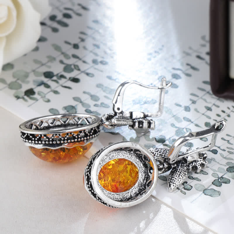 Stylish retro floral dangle earrings for women, featuring radiant amber stones and silver.