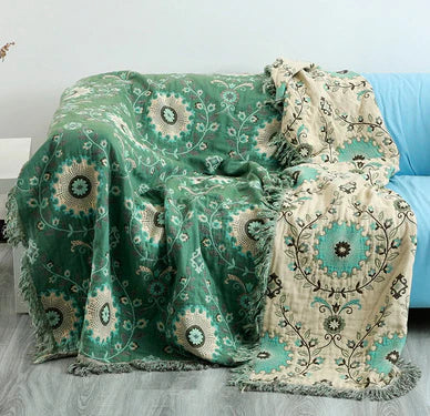 Nordic design reversible cotton blanket with a unique bird and floral motif, suitable as a sofa throw.