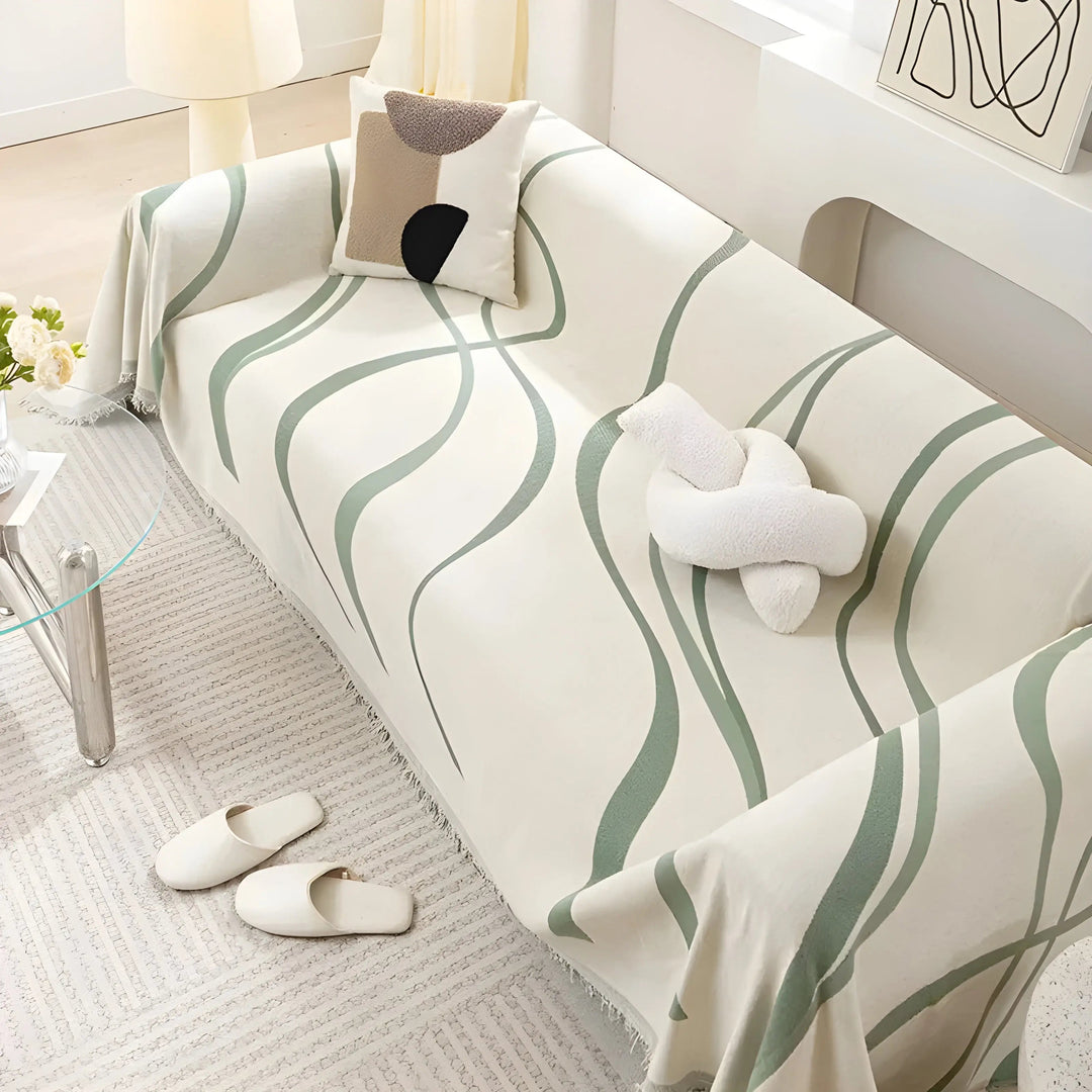 Stylish reversible gray/khaki chenille cotton sofa cover on a couch, providing washable protection & comfort.