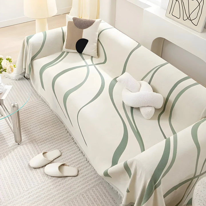 Stylish reversible gray/khaki chenille cotton sofa cover on a couch, providing washable protection & comfort.
