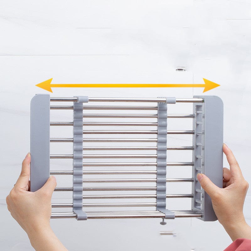 Multifunctional roll-up dish drying rack with dishes over a kitchen sink, saving counter space.