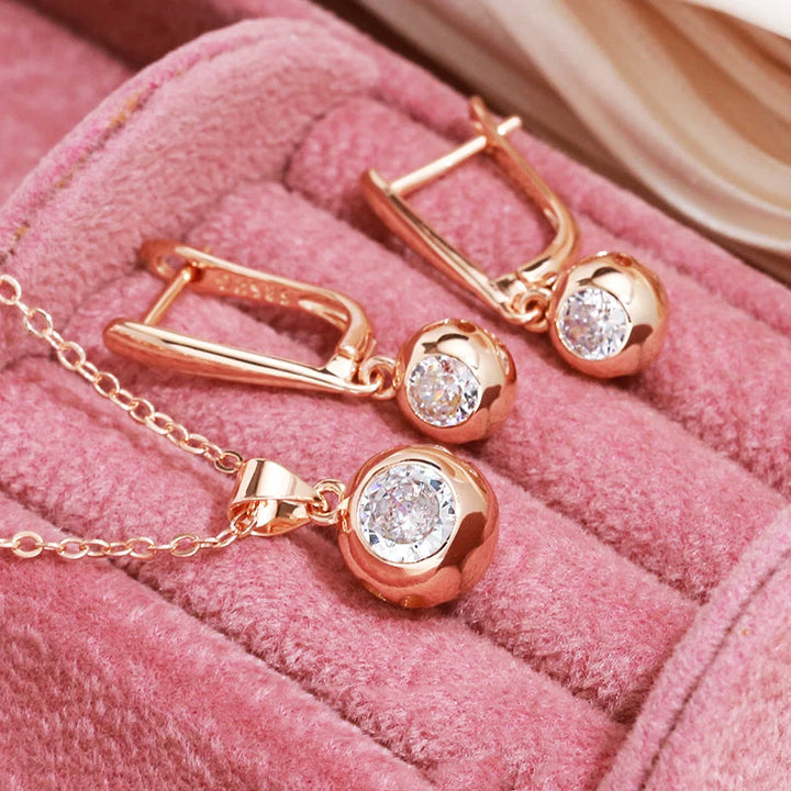 Rose gold women's jewelry set: sparkling zircon orb earrings and matching necklace for an elegant look.