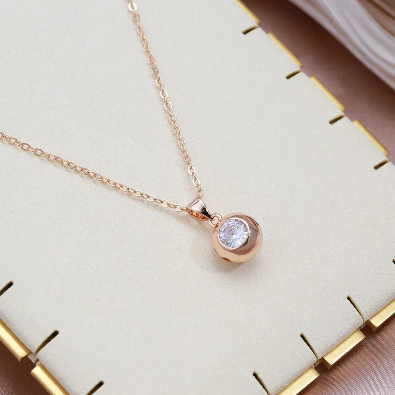 Minimalist rose gold women's jewelry set, featuring delicate zircon orb earrings and a matching necklace.