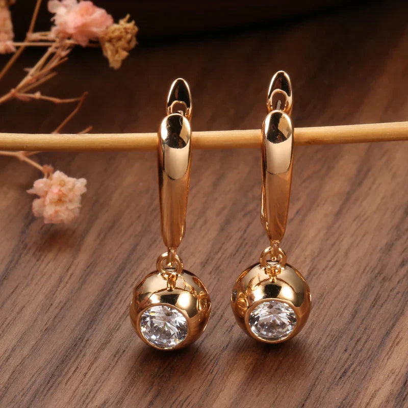 Beautiful women's rose gold zircon jewelry set. Includes dazzling orb earrings and a sleek matching necklace.