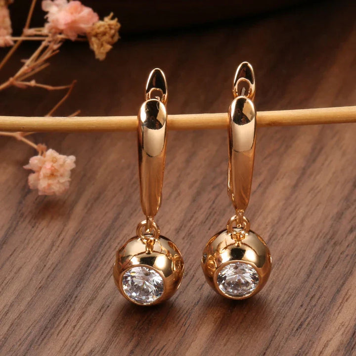 Beautiful women's rose gold zircon jewelry set. Includes dazzling orb earrings and a sleek matching necklace.