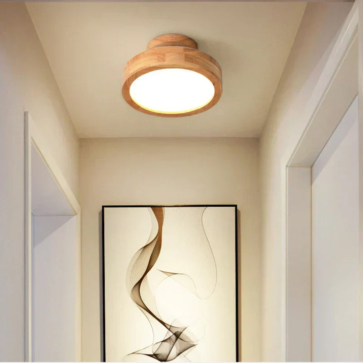 Stylish round wooden LED ceiling light, enhancing modern home decor with soft, ambient illumination.