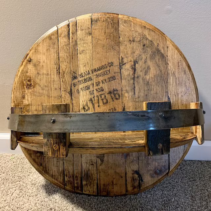 Close-up of a rustic oak bourbon barrel shelf with metal bands, ideal for unique shelving.