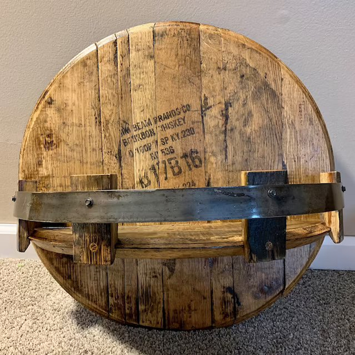 Close-up of a rustic oak bourbon barrel shelf with metal bands, ideal for unique shelving.