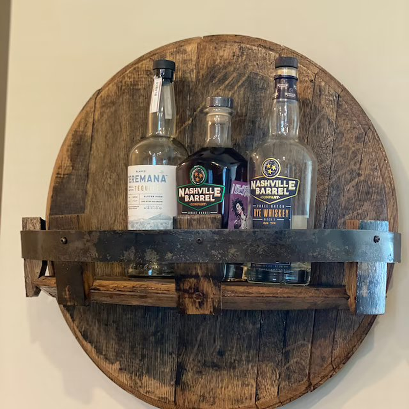 Full view of a wall-mounted bourbon barrel shelf, rustic furniture enhancing any home bar or living space.