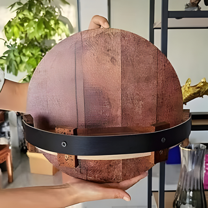 Wall-mounted rustic bourbon barrel half shelf, a unique reclaimed wood piece for home bar spirit display.
