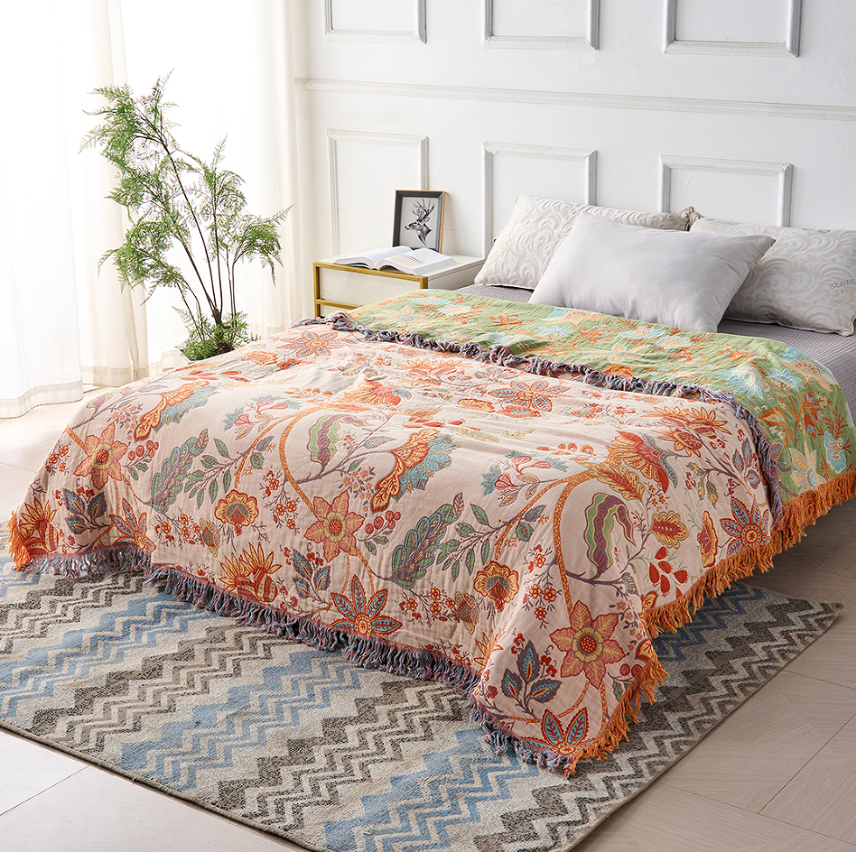 Washable cotton floral blanket; a decorative and soft throw for rustic or bohemian interiors.