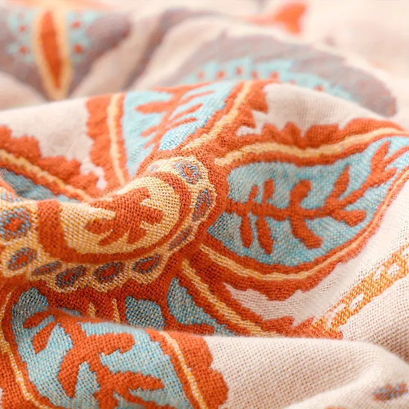 Soft cotton boho blanket with a rustic floral pattern, enhancing any bohemian home decor.