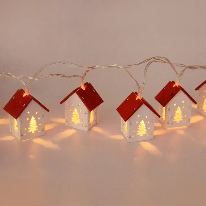 Rustic wooden Christmas house featuring soft LED lighting, creating a magical winter ambiance.