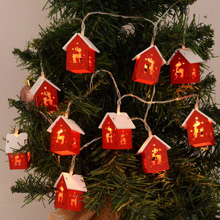 Wooden house ornament with integrated LED lights. A charming piece of Christmas and winter decor.