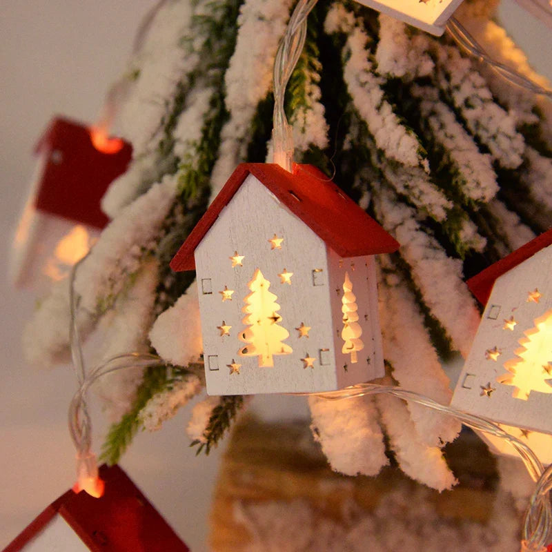 Set of miniature wooden Christmas houses, each with a warm LED glow. Rustic holiday ornaments.