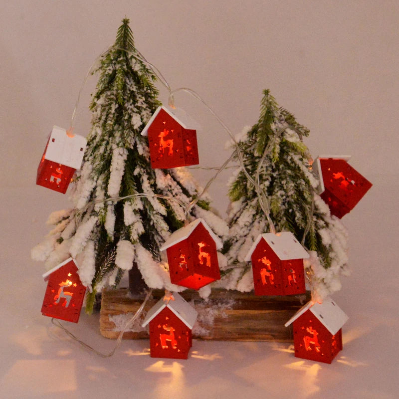 Wooden Christmas house with LED lights, perfect for a festive mantelpiece or shelf display.