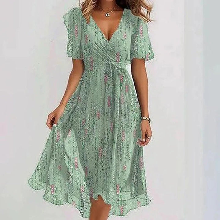 Ocean blue wrap V-neck midi dress for women, with flutter sleeves & a graceful ruffle hem. Casual or occasion wear.