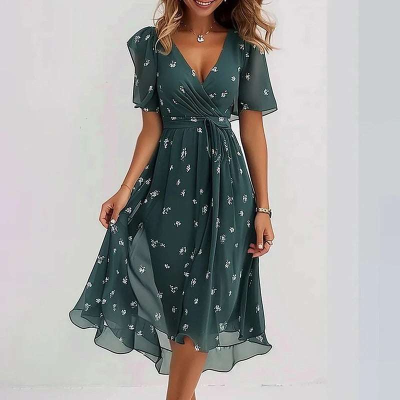 Flowy women's flutter sleeve V-neck wrap midi dress with a ruffle hem. Ideal for elegant summer occasions.