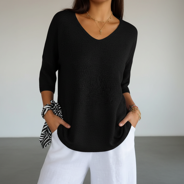 Sapphira V-neck knit top paired with jeans, demonstrating a chic casual summer outfit