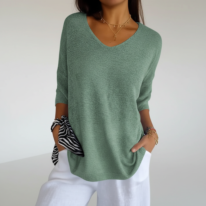 Side view of model in Sapphira women's lightweight V-neck knit top, loose and airy fit