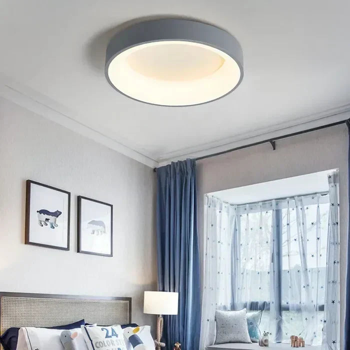 Nordic round LED ceiling lamp providing ambient light for living room or bedroom. Modern & energy-saving.