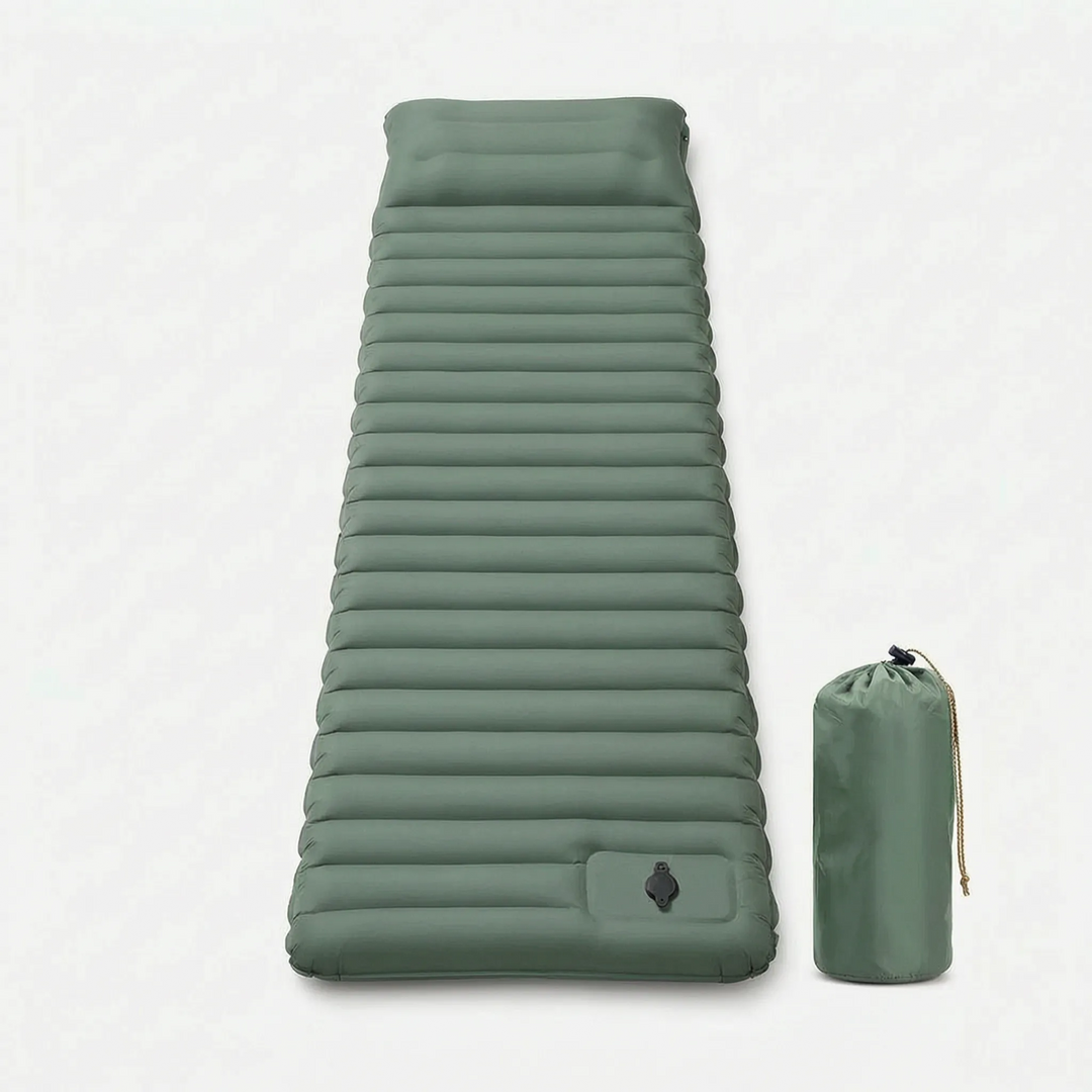Durable, lightweight self-inflating camping pad next to a backpack & tent, ready for a comfortable night.