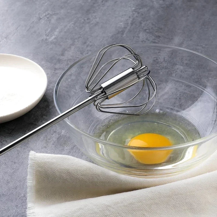 Effortless semi-automatic kitchen whisk; ideal stainless steel gadget for efficient egg beating & stirring.