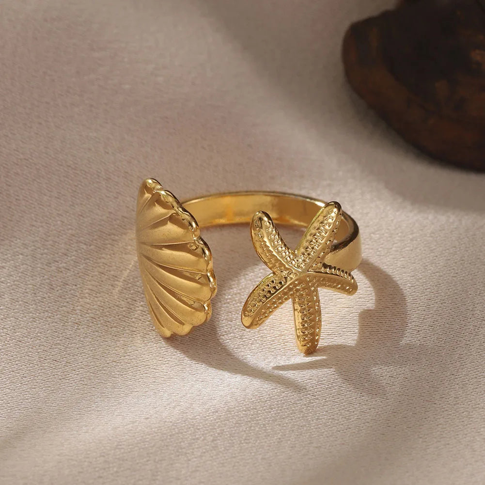 Elegant women's adjustable ocean rings, gold stainless steel, with a detailed seahorse & beach-inspired treasure design. Two-piece set.