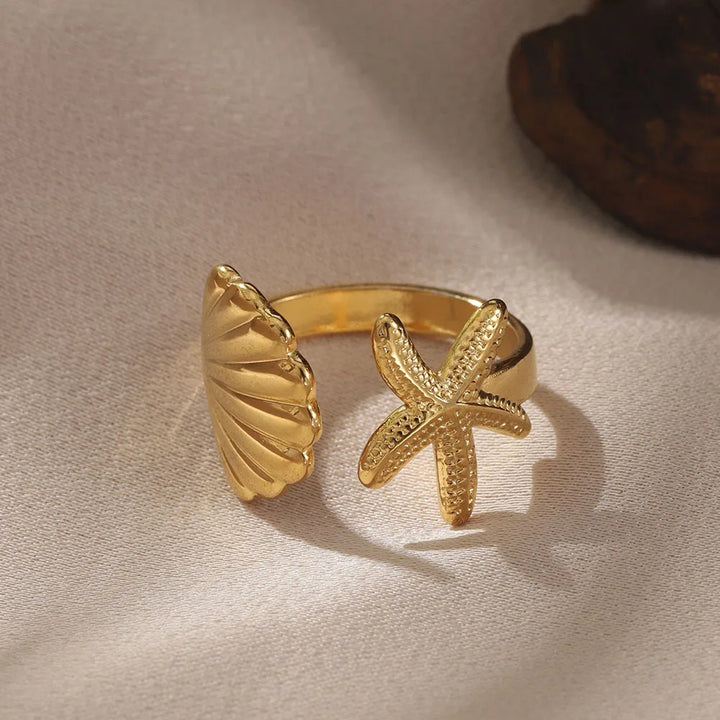 Elegant women's adjustable ocean rings, gold stainless steel, with a detailed seahorse & beach-inspired treasure design. Two-piece set.