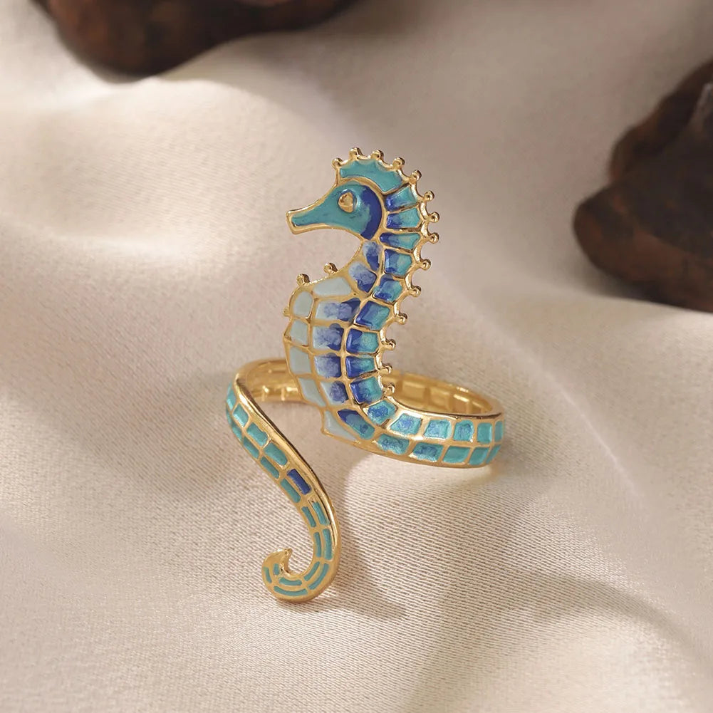 Adjustable gold stainless steel rings, a two-piece set for women, with vibrant enamel seahorse & ocean treasure designs. Ideal gift.