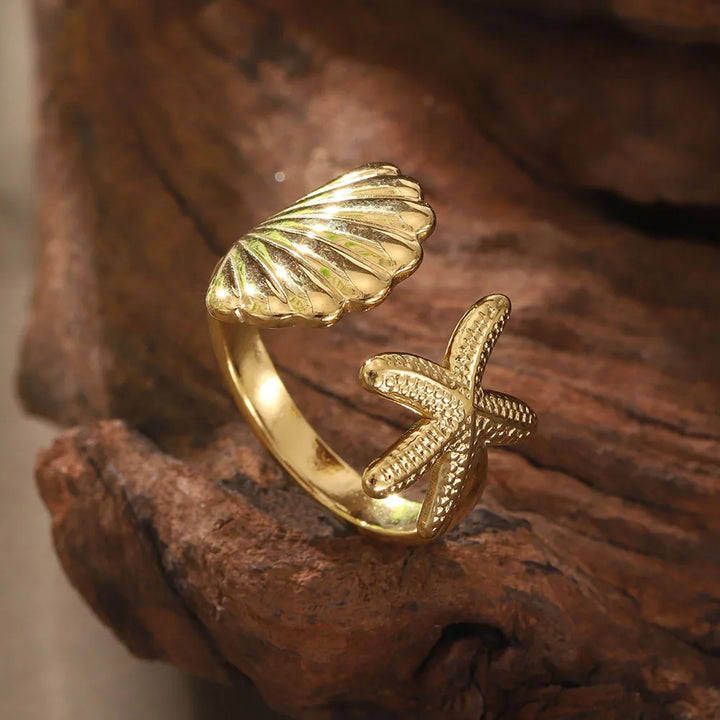 Gold-tone adjustable women's rings (set of 2) featuring intricate enamel seahorse & ocean treasure designs in durable stainless steel.