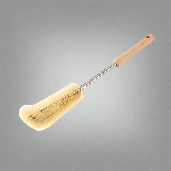 Close-up of the brush head of a long-handled wooden bottle cleaner, highlighting sturdy bristles.