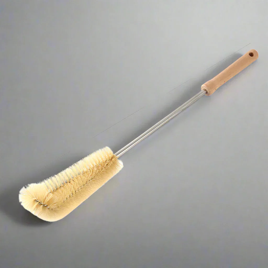 Ergonomic long-handled wooden bottle brush for efficient cleaning of narrow-necked bottles and jars.
