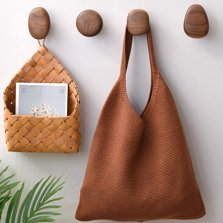 Set of decorative pebble wooden wall hooks for modern home decor. Natural wood entryway and coat organization.