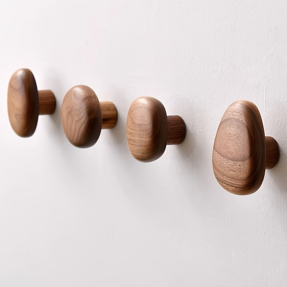 Multiple natural wood pebble wall hooks, a decorative set for coat hanging, towels & modern home organization.