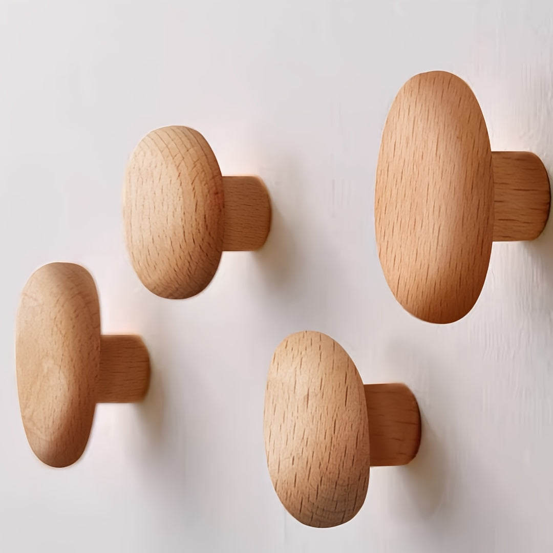 Simple, natural wood pebble wall hooks for contemporary home decor. Perfect for coats, towels, and bags.