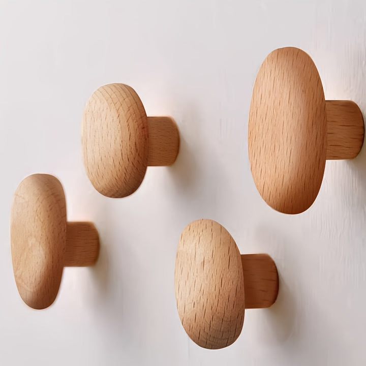 Simple, natural wood pebble wall hooks for contemporary home decor. Perfect for coats, towels, and bags.