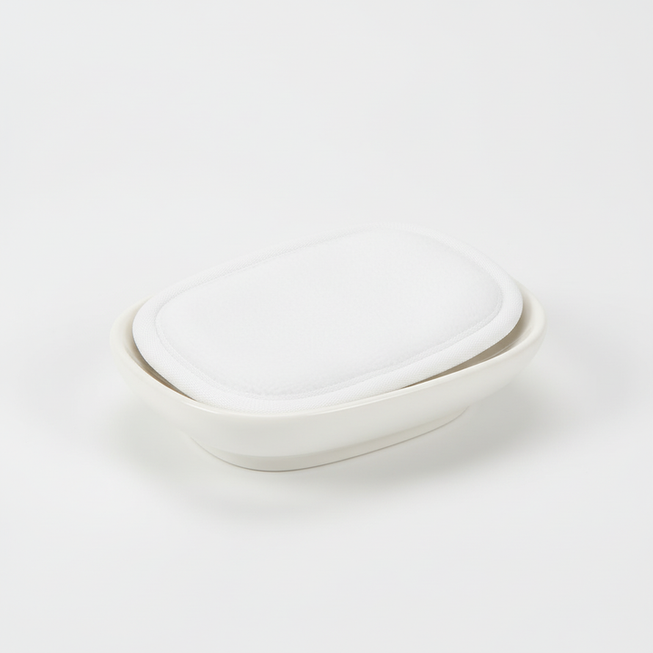 CleanAway reusable makeup remover pad gently wiping away makeup from a face, illustrating its use