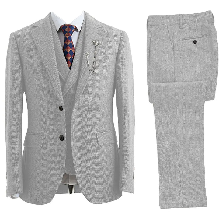 Elegant men's 3-piece herringbone wedding suit. Classic formal wear for a sophisticated groom or special occasion.