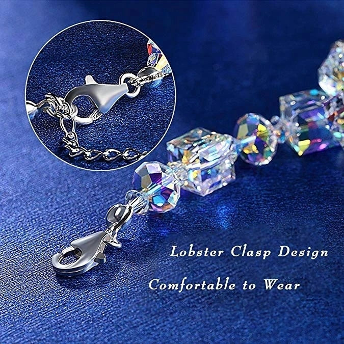 Close-up of a women's sparkling cubic zirconia crystal bracelet, delicate adjustable silver design.