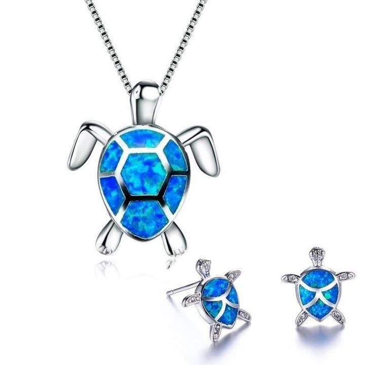 Dainty silver sea turtle stud earrings with opal inlay for women. Matching set, nature-inspired marine life.